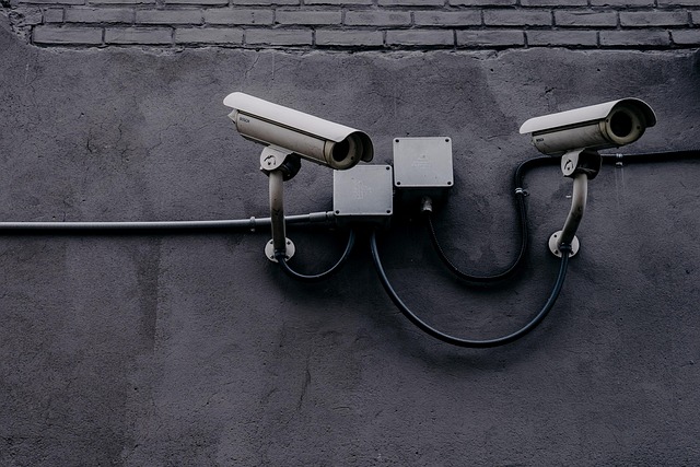 Two security cameras mounted on a wall